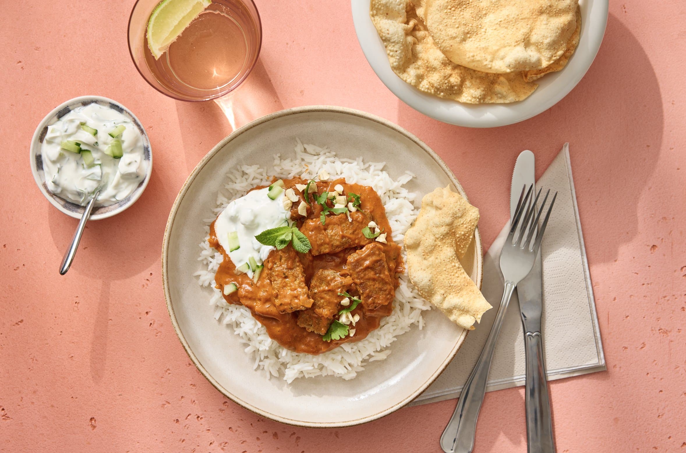 Millow butter chicken served with rice, yoghurt and papadum