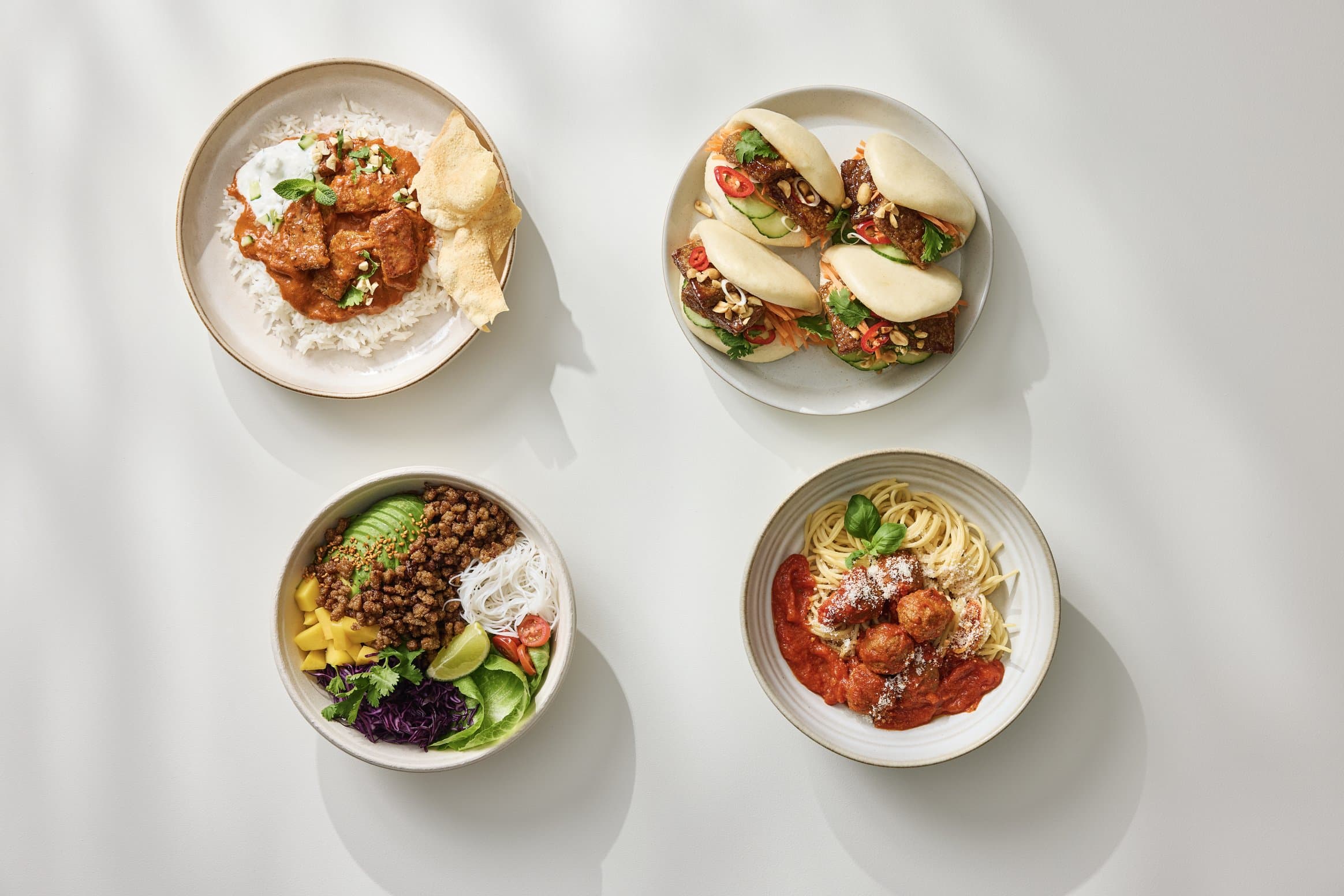 Four Millow dishes photographed from above on a light table