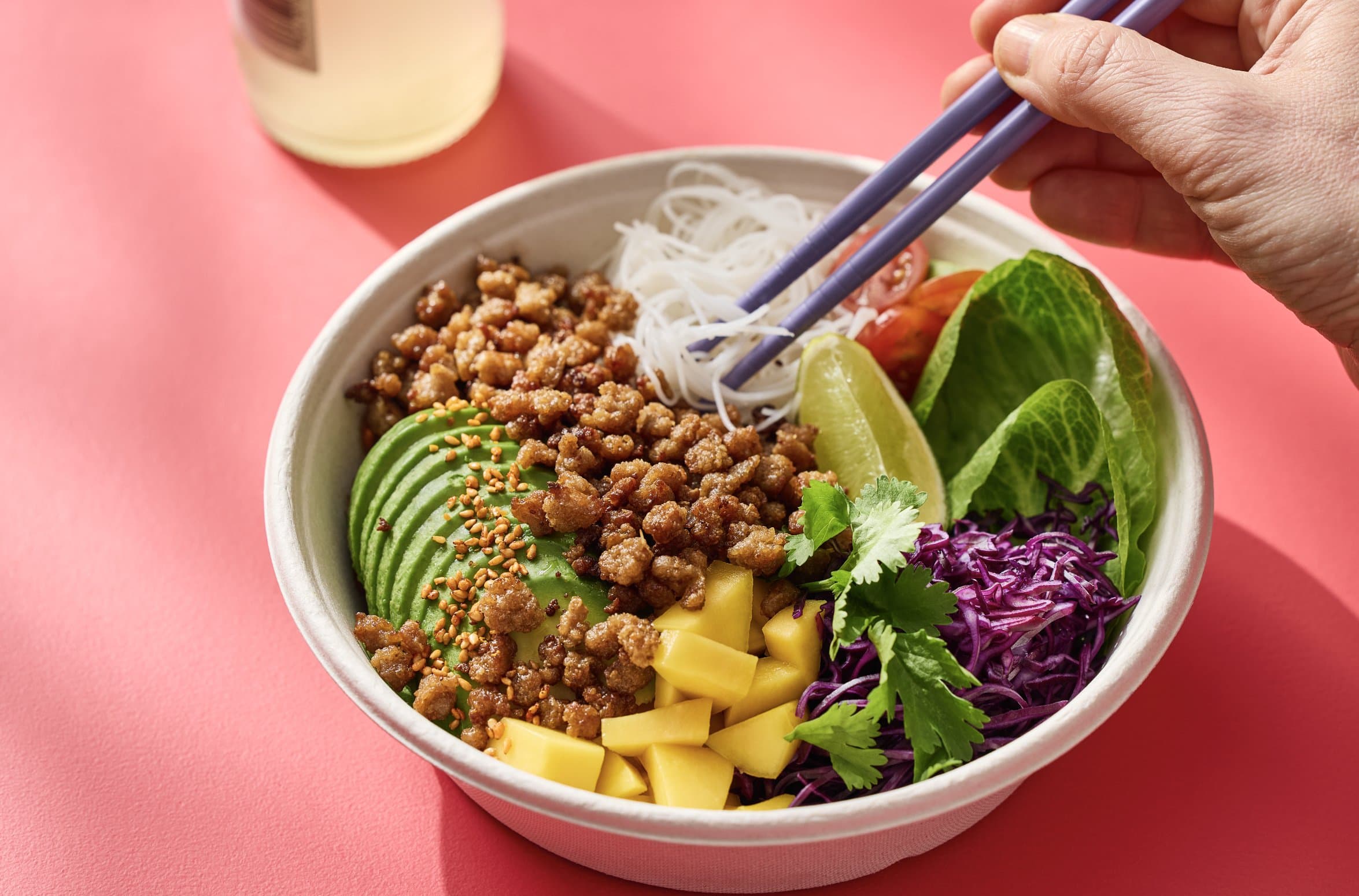 Poke bowl with crumbled Millow, avocado, mango and red cabbage